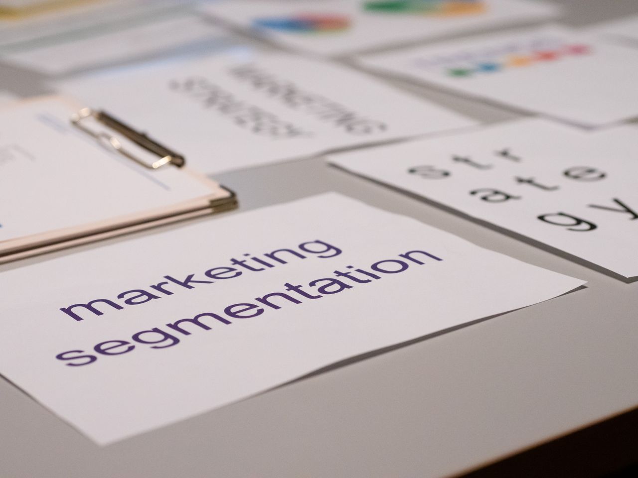 contact-img Close-up of various marketing documents on a desk, perfect for business and strategy discussions.